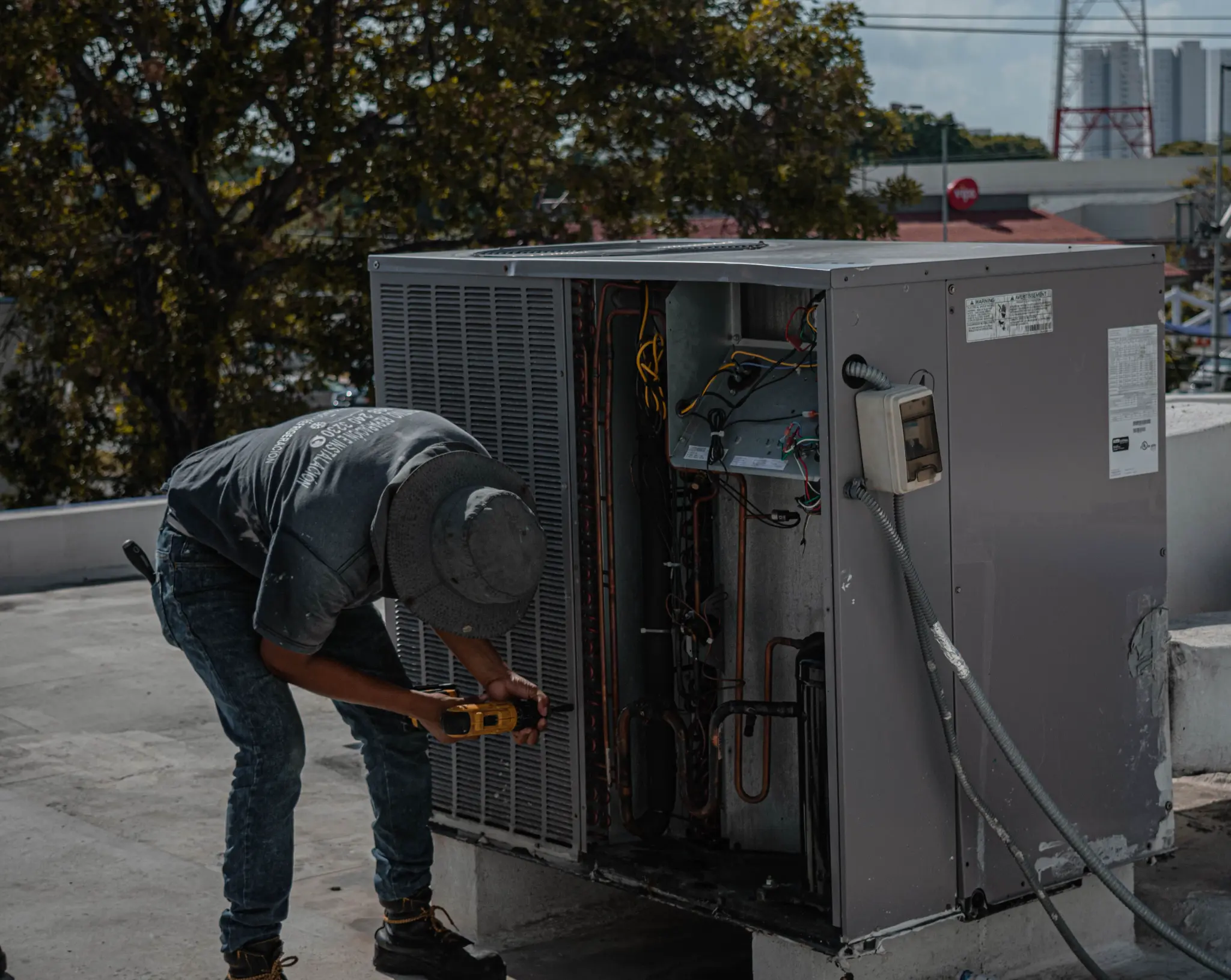 HVAC technician diagnosing a large outdoor cooling system
